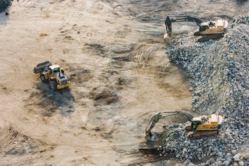 three-yellow-excavators